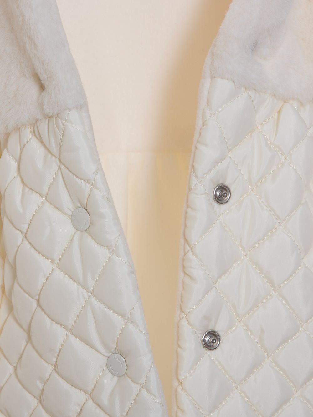 Ecru fur and quilted raincoat