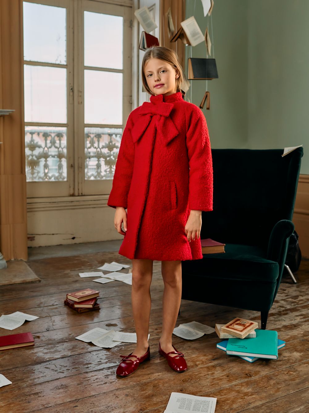 Red bouclé coat with bow