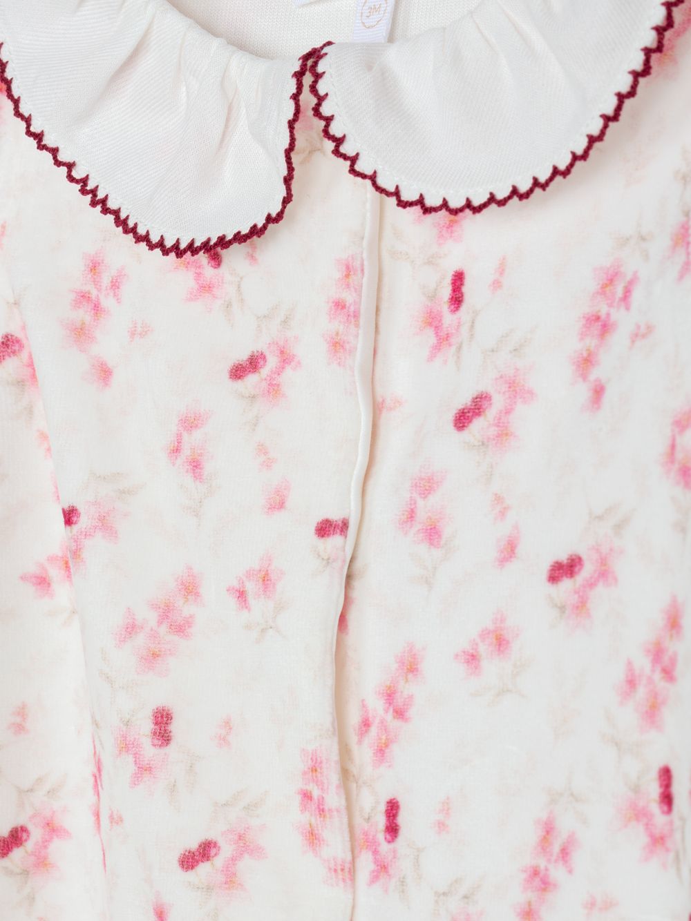 Pink babygrow with floral print