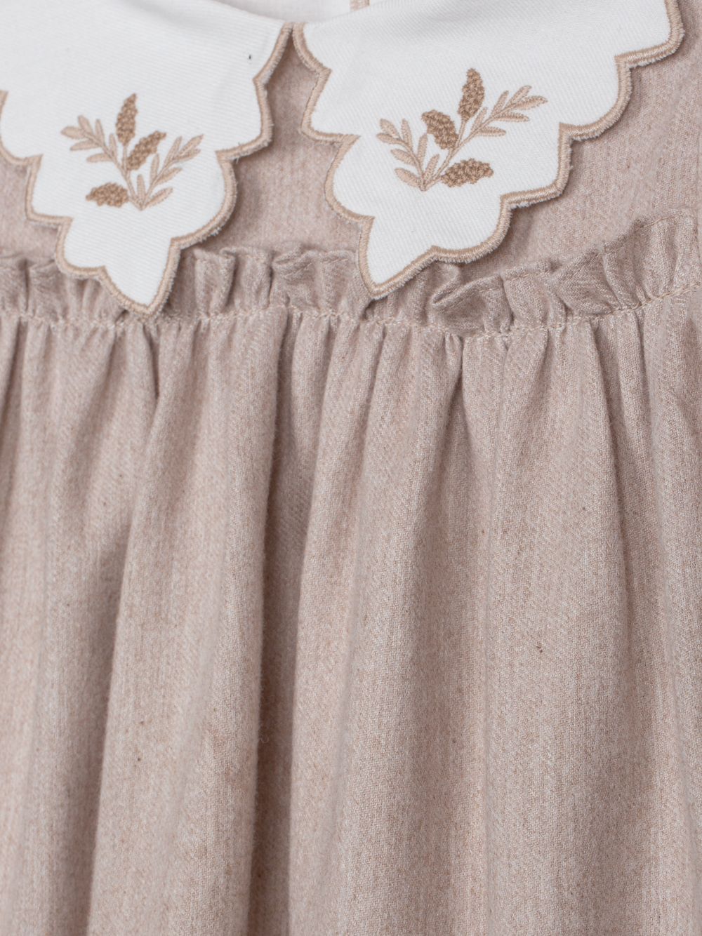 Elegant beige dress with embroidered collar