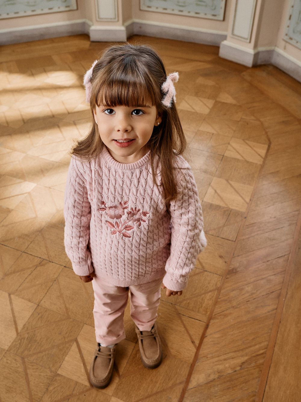 Pale pink knitted sweater with embroidered design