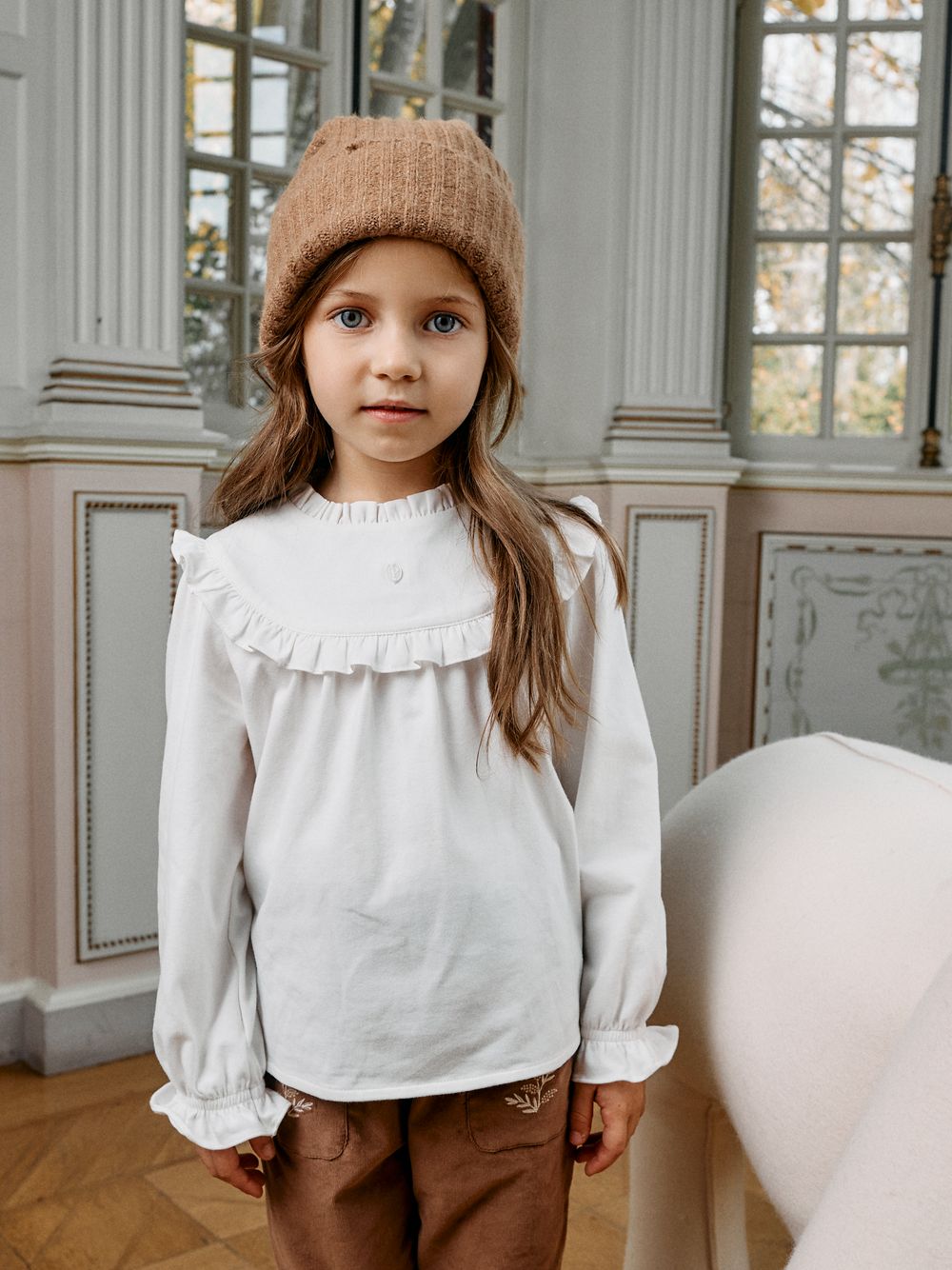 Elegant ecru blouse with ruffles