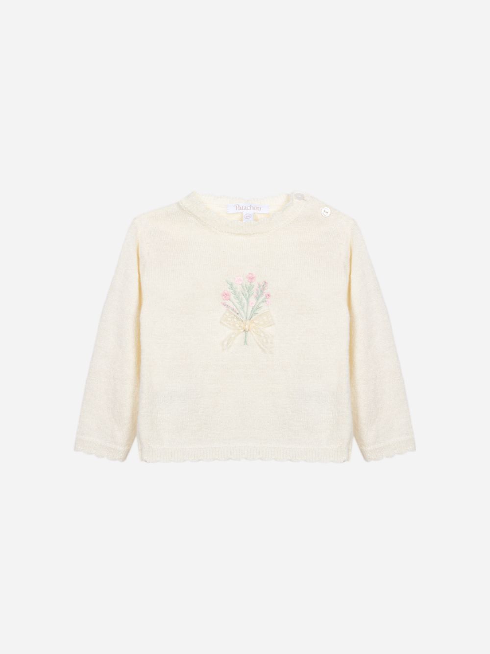 Ecru knit sweater with a design on the front