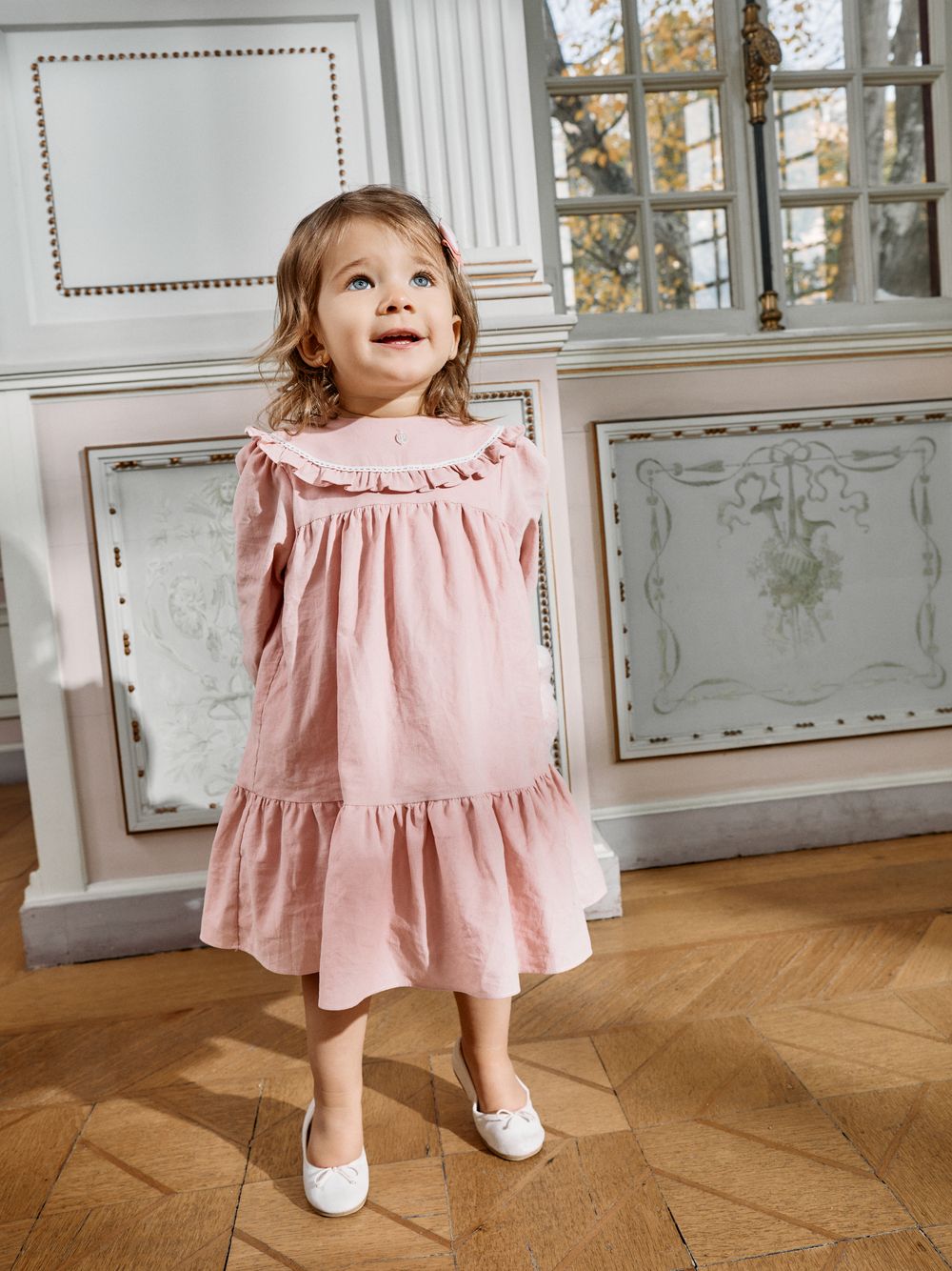 Pale pink dress with an elegant collar and ruffles
