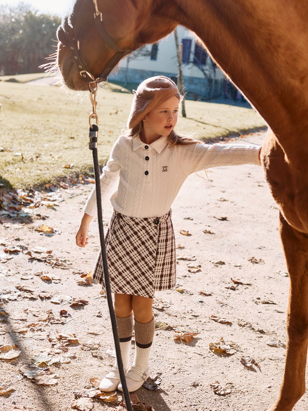 Ecru polo shirt with buttons and elegant embroidery