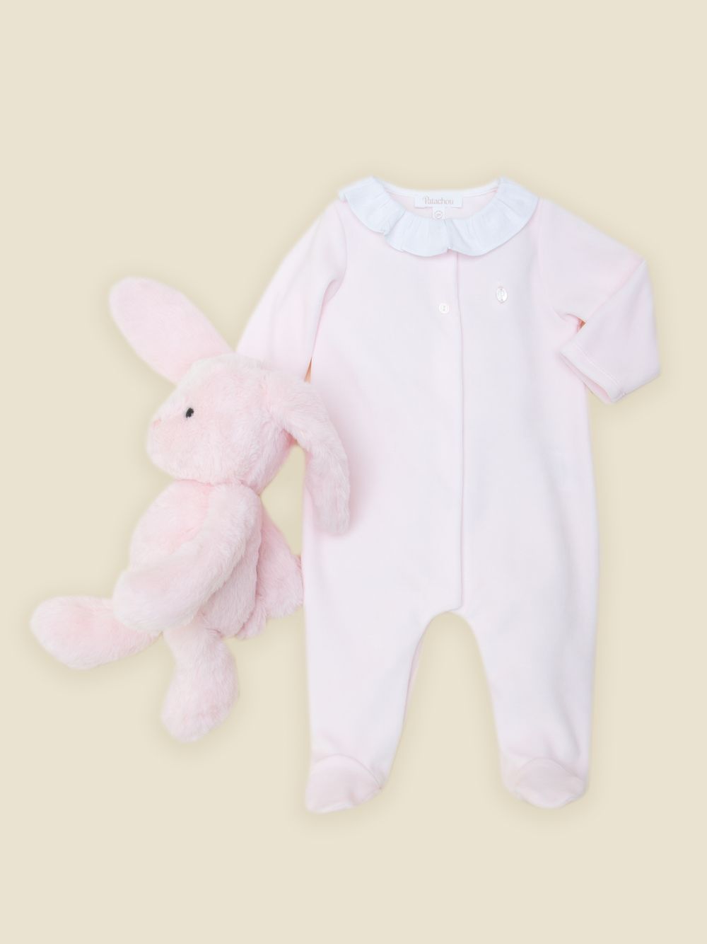 Pink babygrow with a white ruffled collar