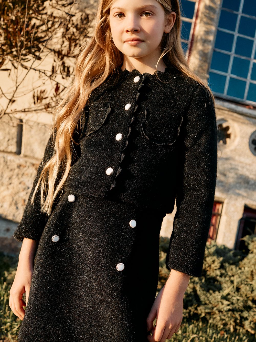 Elegant black coat with buttons and refined details