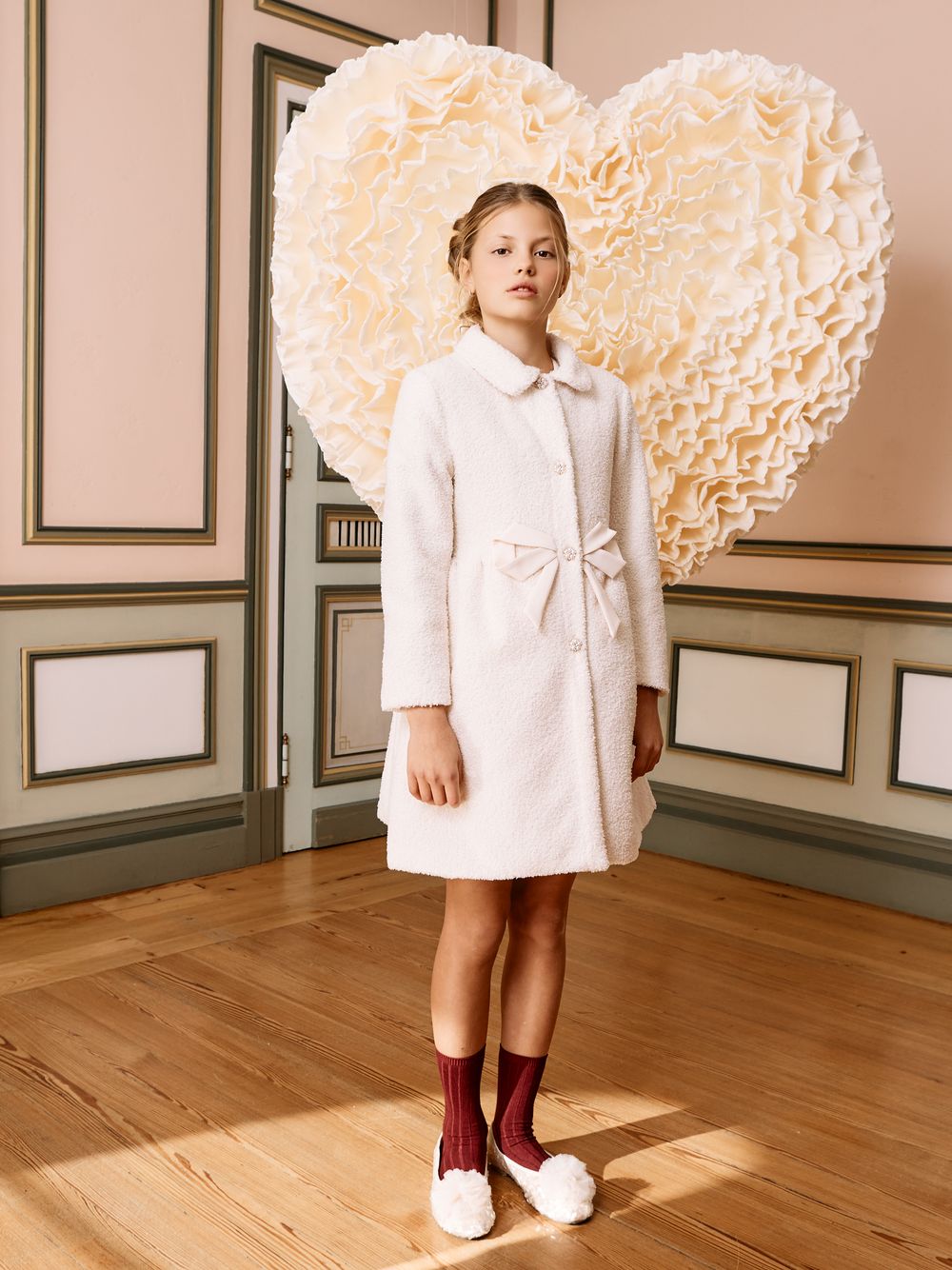 Beige bouclé coat with an elegant bow
